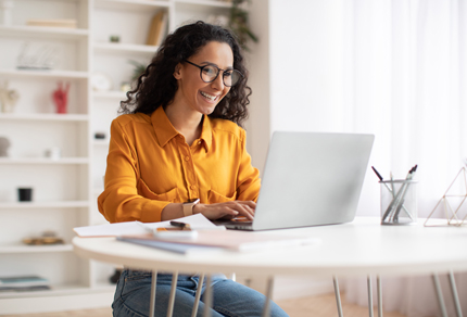 Woman smiling at laptop
