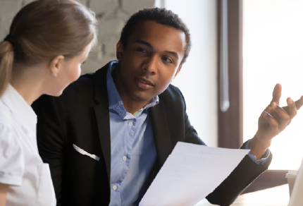 Two colleagues talking at a table 