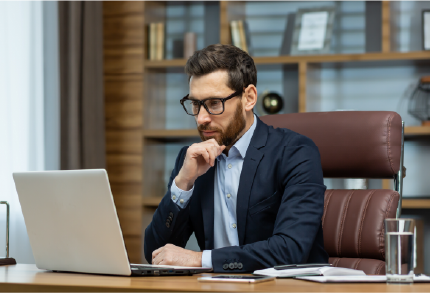 Middle-aged man looking at laptop.